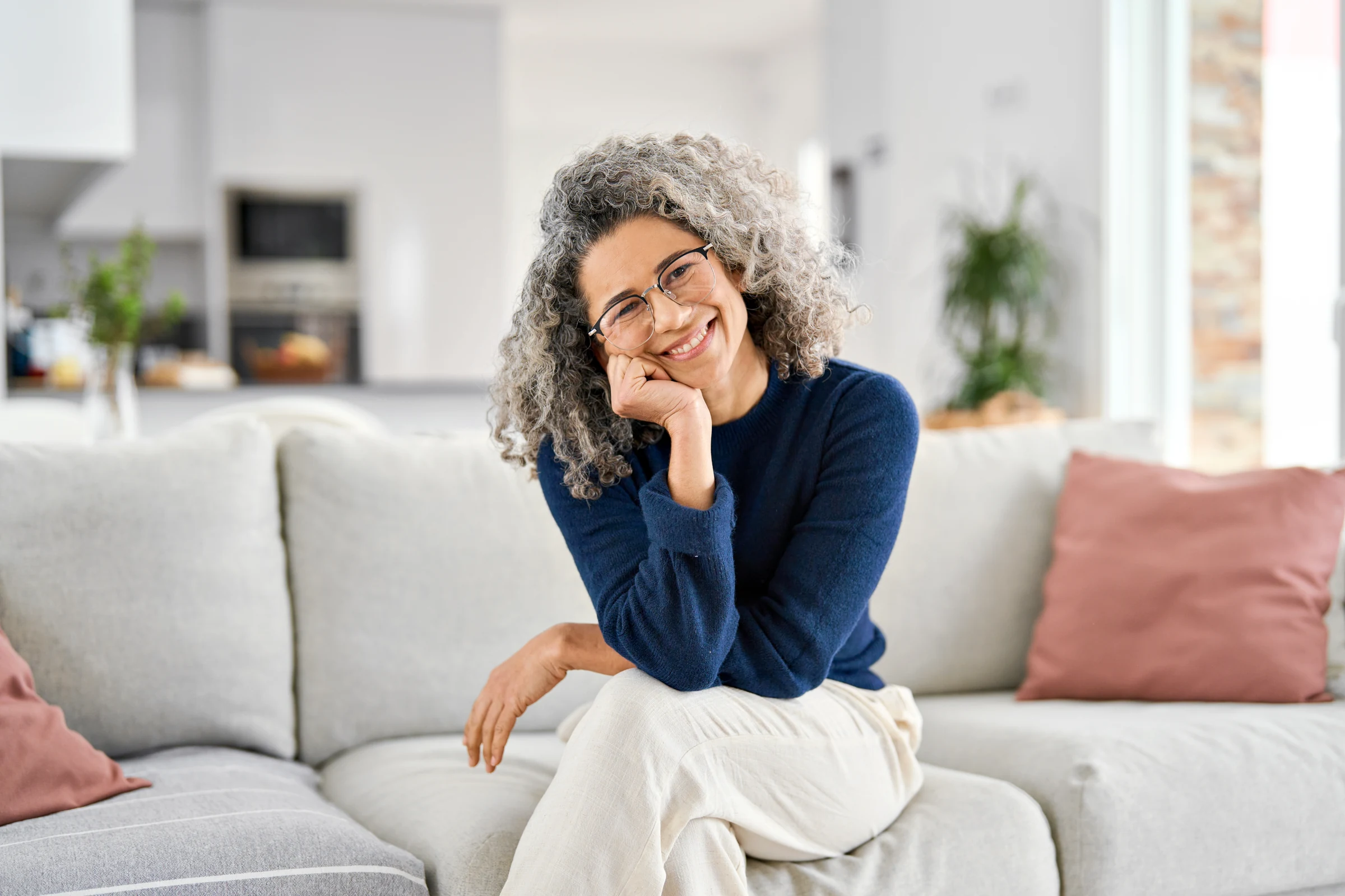 Woman with glasses smiling at home